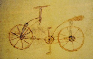 One of the great mysteries surrounding Leonardo’s life and work … during the restoration of the Codex Atlanticus (A twelve-volume, bound set of drawings and writings by Leonardo da Vinci, the largest such set; its name indicates its atlas-like breadth. It comprises 1,119 leaves dating from 1478 to 1519, the contents covering a great variety of subjects, from flight to weaponry to musical instruments and from mathematics to botany), the above drawing was found between two glued-in pages.  The lack of detail in the drawing and the signature of Leonardo’s pupil, Salai, lead scholars to believe that Salai may have drawn this image by sketching a model seen in his master’s workshop, a common practice for apprentices of the time.  Notes and other sketches found in the Codex clearly demonstrate that Leonardo had all of the technical knowledge required to build this bicycle.