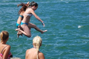Kids jumping off the Port channel breakwater
