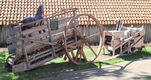 A Grain and Seed Cleaner & Separator – One horse walking continuously on the treadle system creates the power to turn the giant wheel which moves the belt bringing the needed power to the large machine to separate the grain from the chaff and this the term, “One Horse Power!