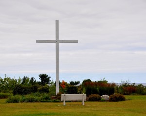 A replica of Father Marquette's cross stands at the edge of the bluff and is visible off the shore, far into Lake Michigan.