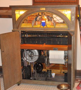 J.P. Seeburg KT cabinet piano – circa 1920 (with its Eagle stained glass, it had a xylophone, castanets, triangle and tambourine … but no keyboard. It was the forerunner of the jute box and was popular in restaurants and bars)