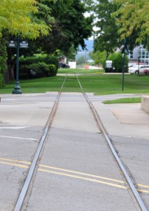 Abandoned railroad tracks lead to a city park