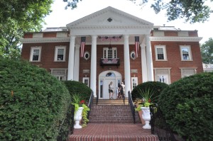 This elegantly proportioned Georgian structure is set off by red Harvard brick and while Corinthian columns.